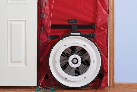 Blower door fan and red fabric panel fitted into an interior doorway for an air-leakage test
